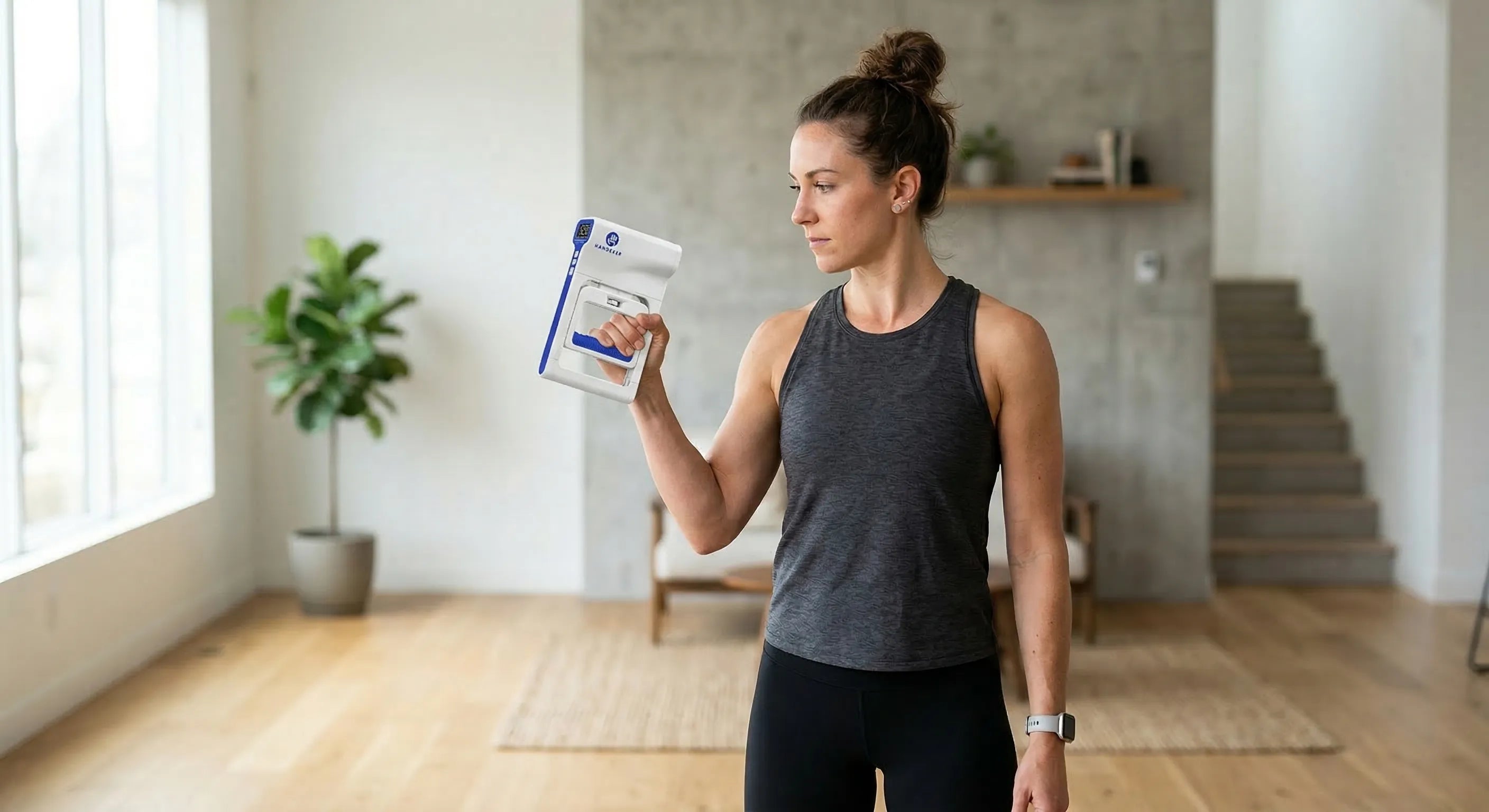 Woman using a digital hand dynamometer grip strength tester at home fitness workout