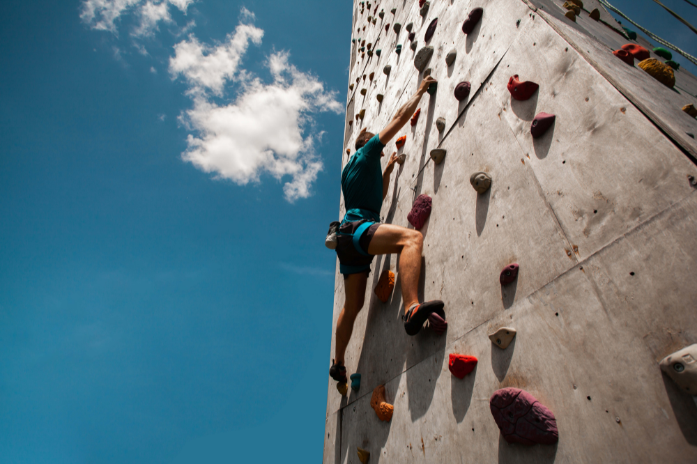 young man exercising indoor climbing